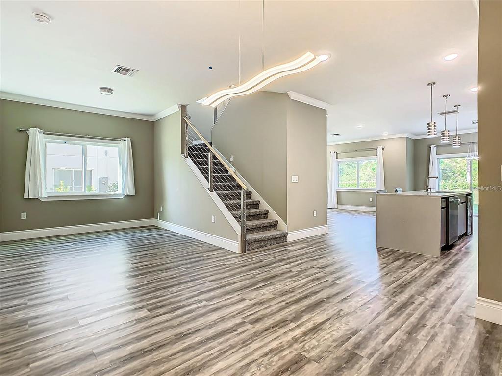 2000 Greenbriar Terrace Davenport, FL 33837 - Photo 2 of 50 a view of a livingroom with wooden floor and stairs