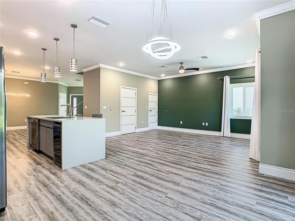 2000 Greenbriar Terrace Davenport, FL 33837 - Photo 31 of 50 a view of a kitchen with a refrigerator a ceiling fan and wooden floor