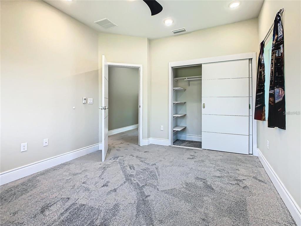 2000 Greenbriar Terrace Davenport, FL 33837 - Photo 44 of 50 an empty room with closet and mirror
