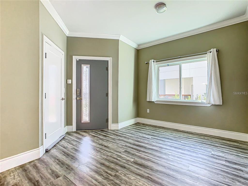 2000 Greenbriar Terrace Davenport, FL 33837 - Photo 49 of 50 a view of an empty room with wooden floor and a window