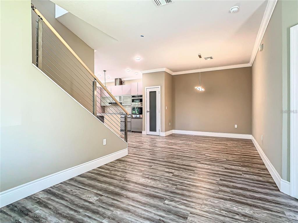 2000 Greenbriar Terrace Davenport, FL 33837 - Photo 8 of 50 a view of an empty room with wooden floor and stairs