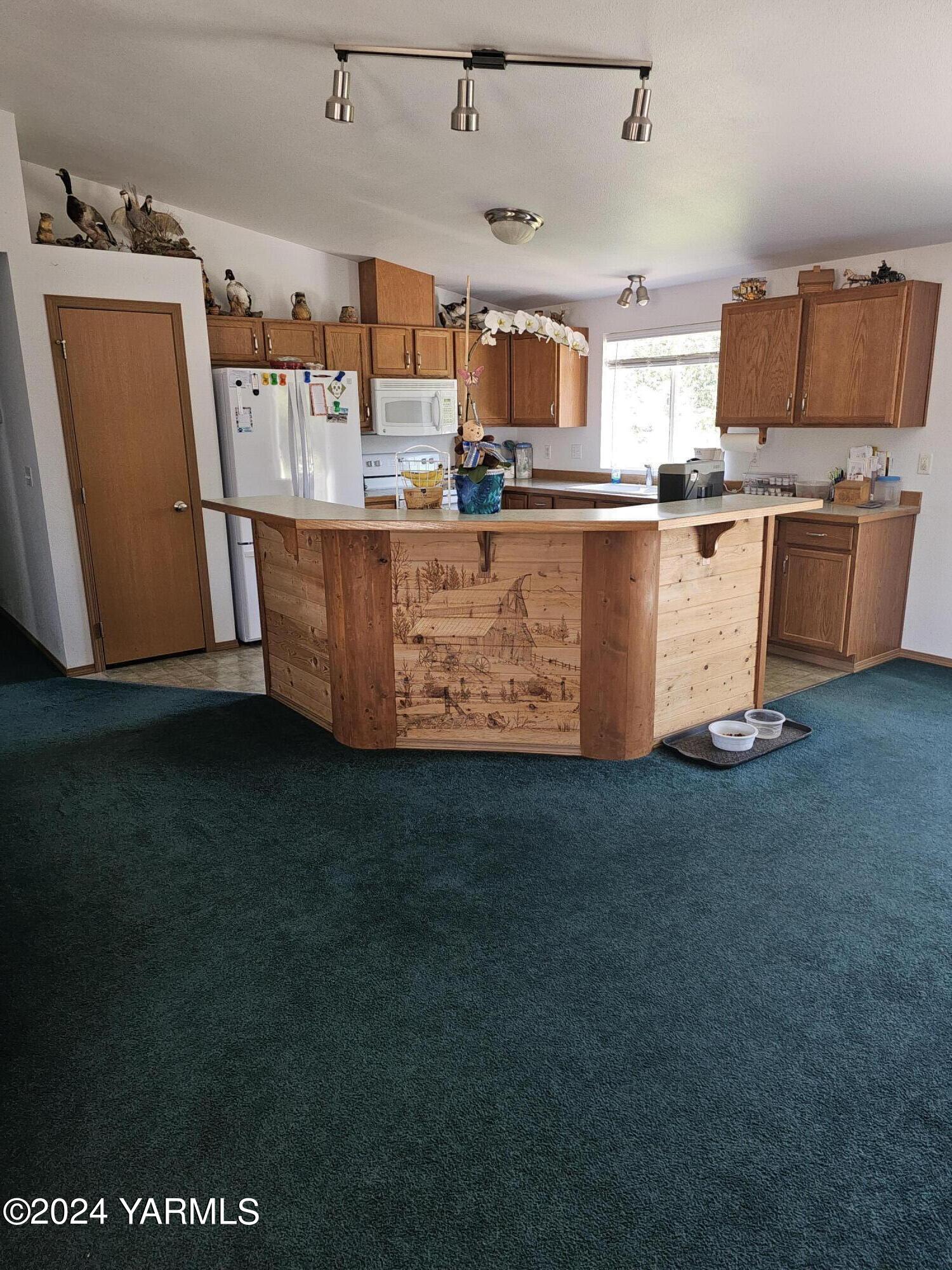 12933 Missimer Road Prosser, WA 99350 - Photo 2 of 39 a kitchen with stainless steel appliances granite countertop a refrigerator a stove and a sink