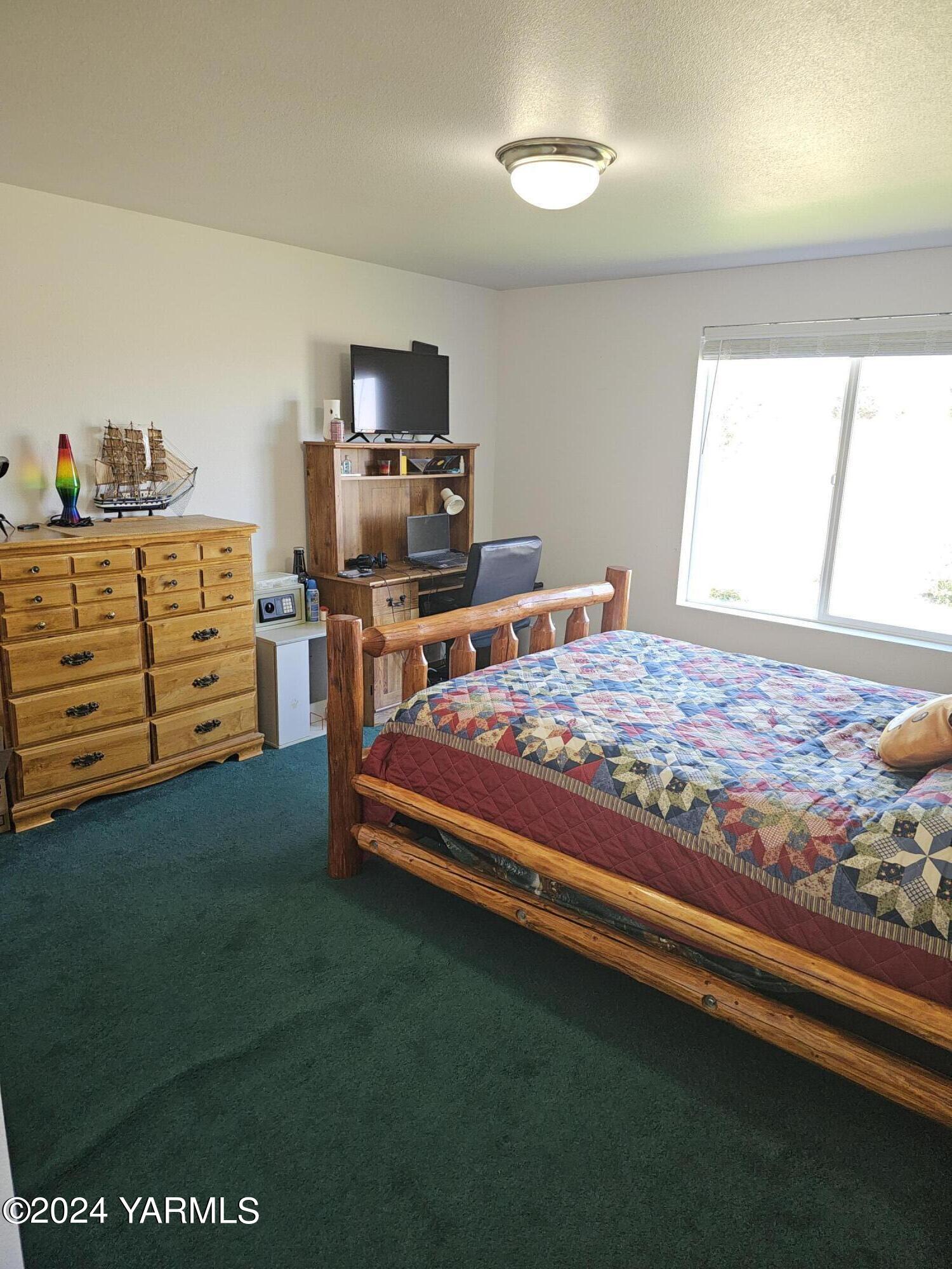 12933 Missimer Road Prosser, WA 99350 - Photo 5 of 39 a bedroom with a bed and furniture