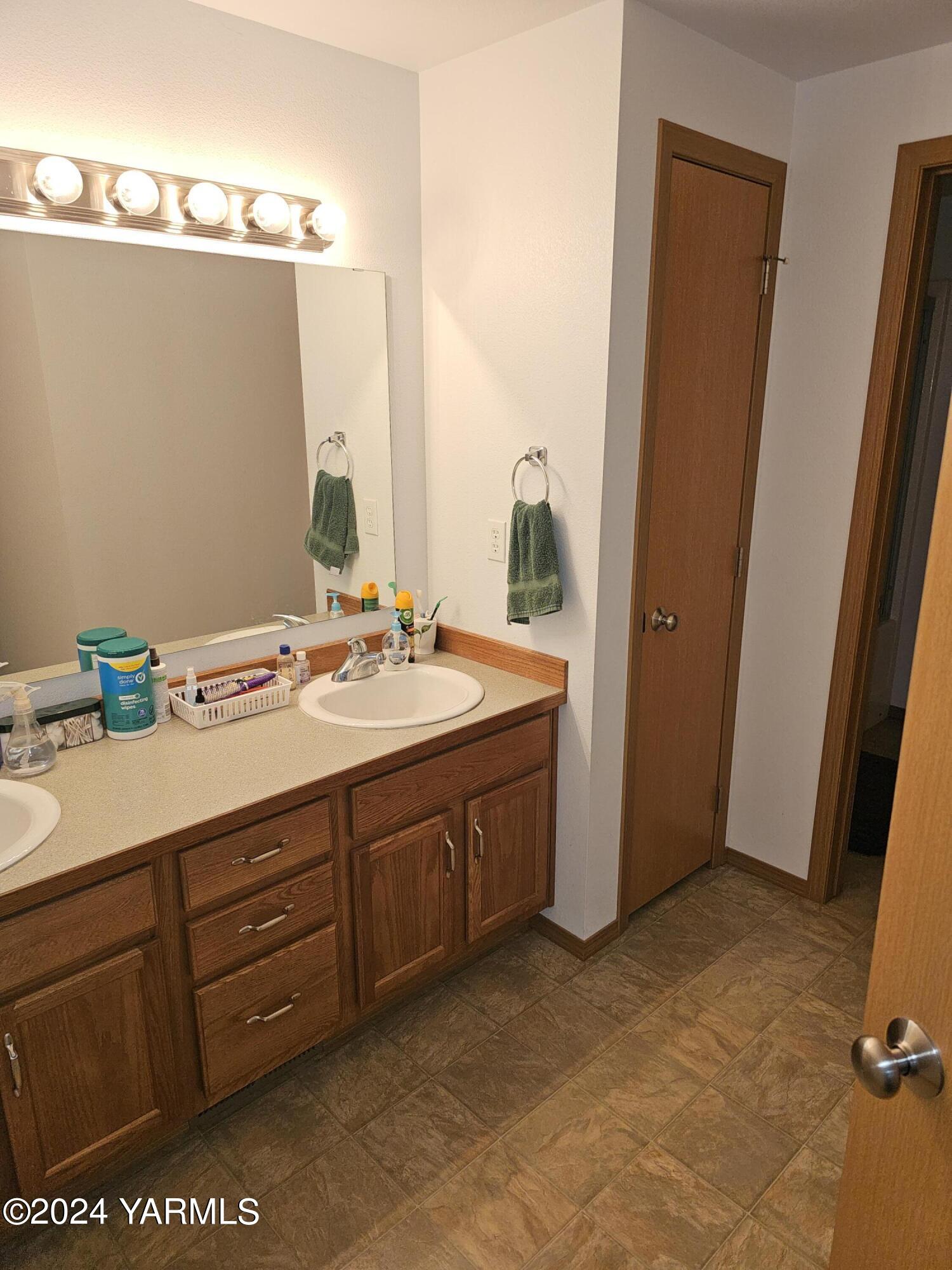 12933 Missimer Road Prosser, WA 99350 - Photo 6 of 39 a bathroom with a granite countertop sink and a mirror