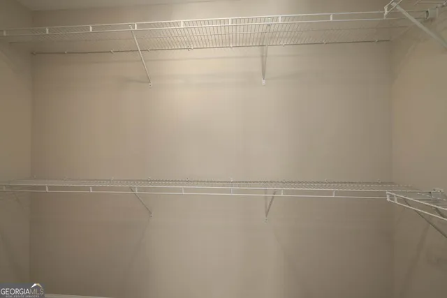 a porch with a floor to ceiling window next to a yard