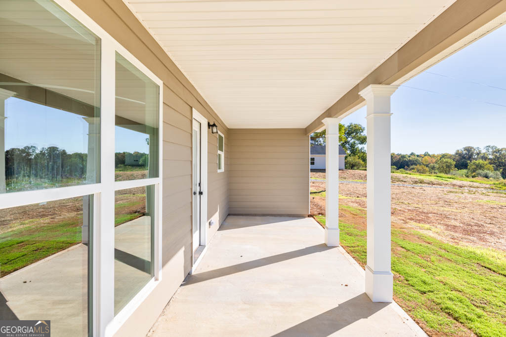 1247 Anderson Thomas Road, Unit 9 Martin, GA 30557 - Photo 30 of 30 a porch with a floor to ceiling window next to a yard