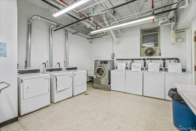 a utility room with cabinets dryer and washer