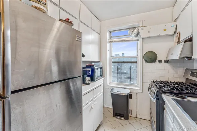 a kitchen with stainless steel appliances granite countertop a refrigerator and a stove