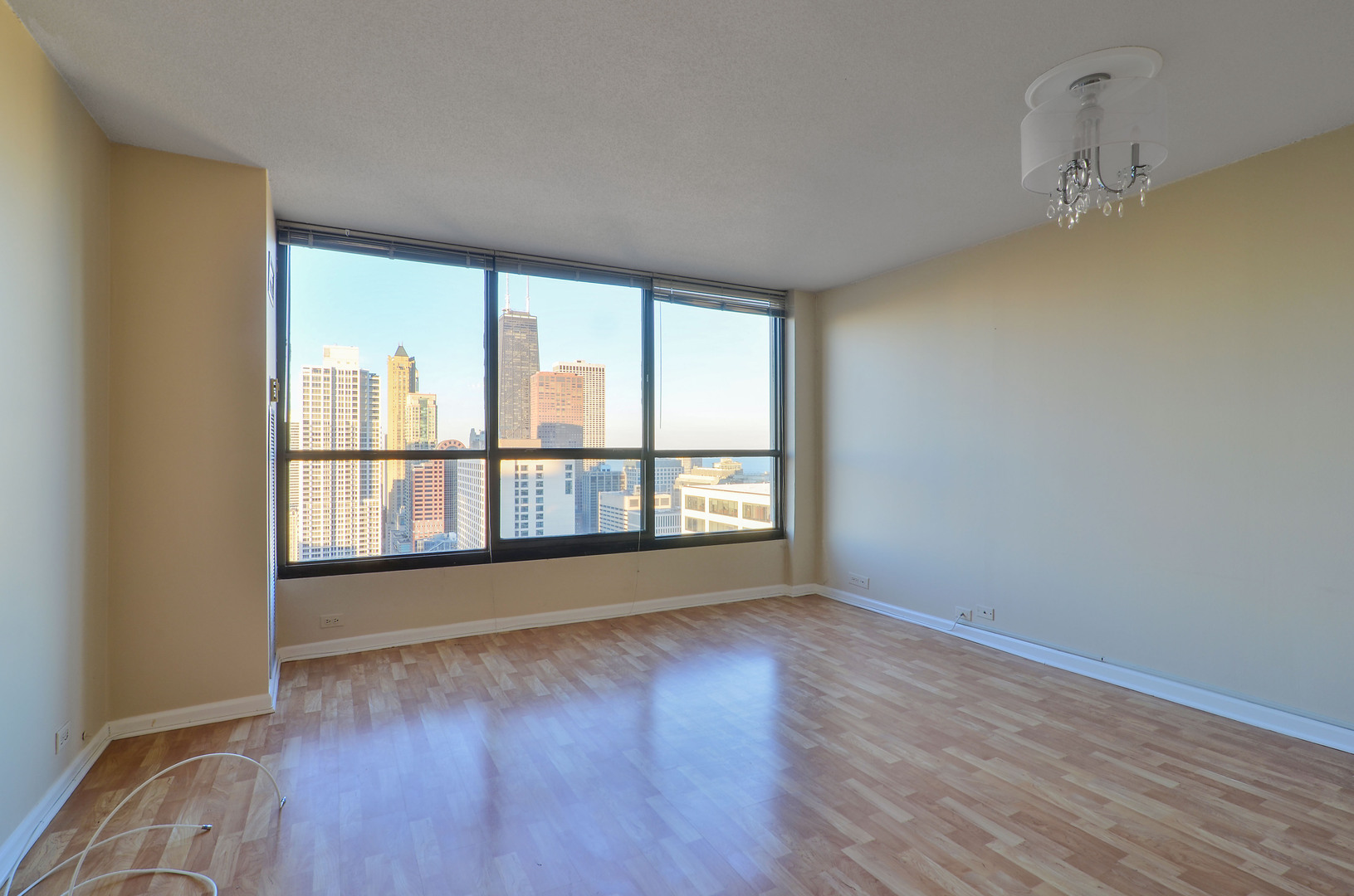 405 North Wabash Avenue, Unit 4512 Chicago, IL 60611 - Photo 2 of 20 wooden floor in an empty room with a window