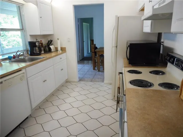 a kitchen with a sink a stove and a refrigerator