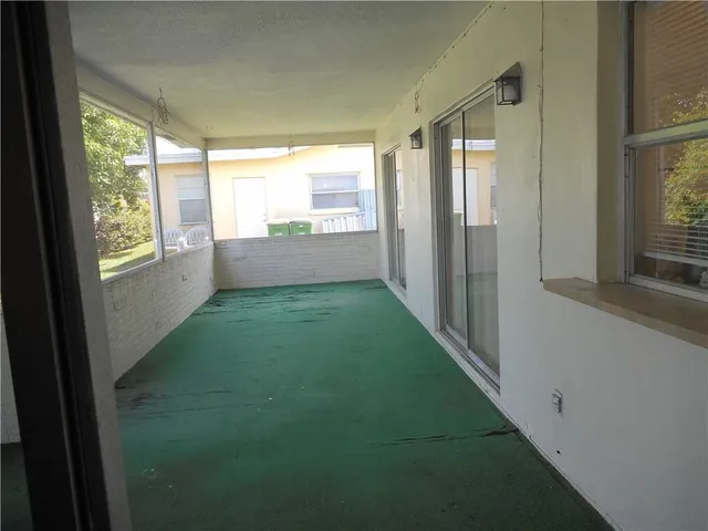 a view of an empty room and a window