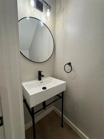 a bathroom with a sink a mirror and a toilet