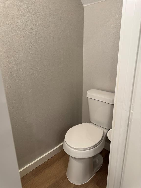 1505 Park Street, Unit A Commerce, TX 75428 - Photo 14 of 25 a white toilet sitting next to a white wall