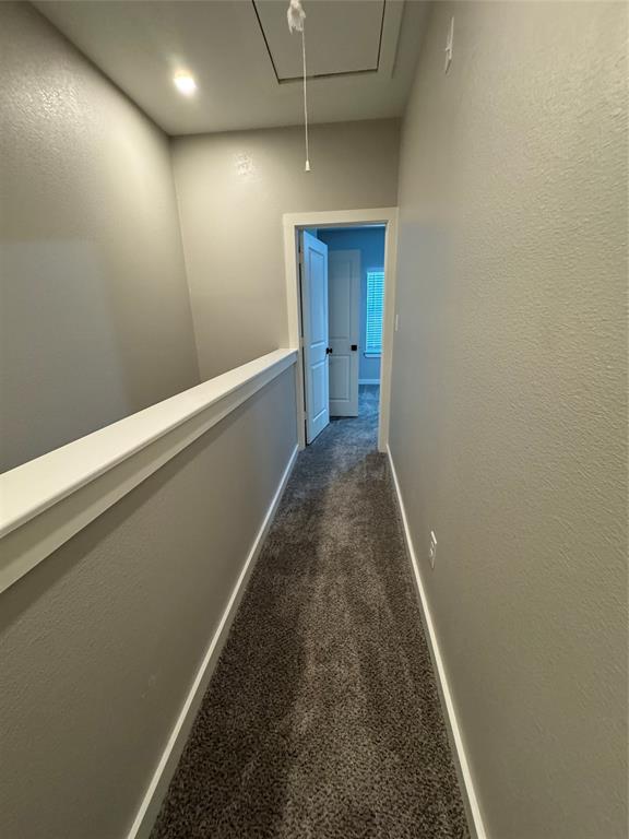 1505 Park Street, Unit A Commerce, TX 75428 - Photo 16 of 25 a hallway with sliding door and wooden floor