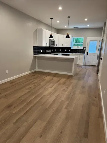a kitchen with stainless steel appliances granite countertop a sink and a stove