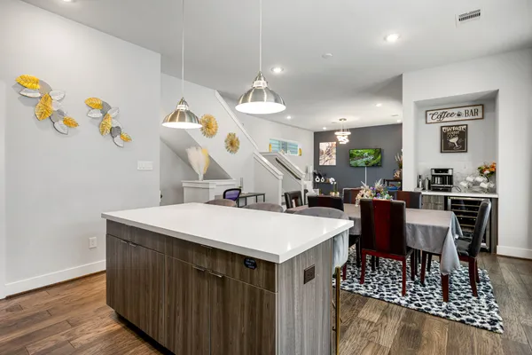 a large kitchen with a table and chairs