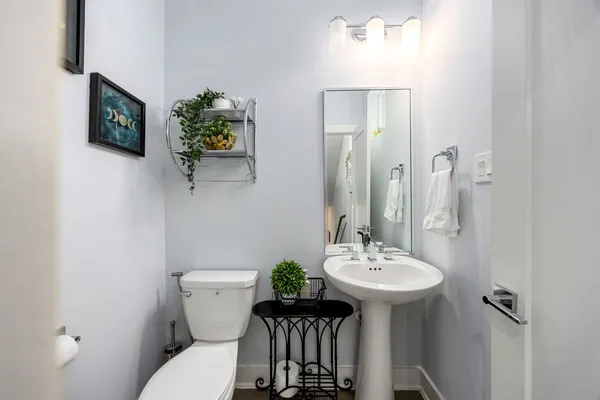 a bathroom with a toilet a sink and a mirror