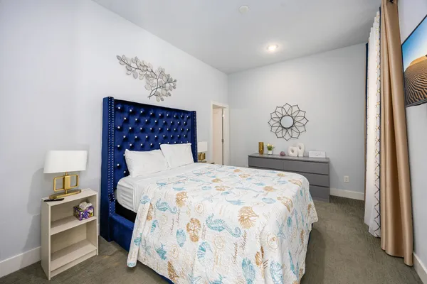 a bedroom with a bed and a painting on the wall