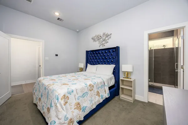 a large bed sitting in a bedroom and a table