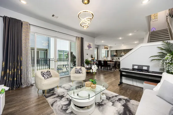 a living room with furniture and wooden floor