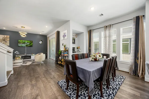 a view of a dining room with furniture and wooden floor