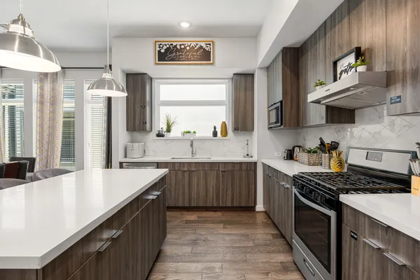 a kitchen with stainless steel appliances a sink stove and cabinets
