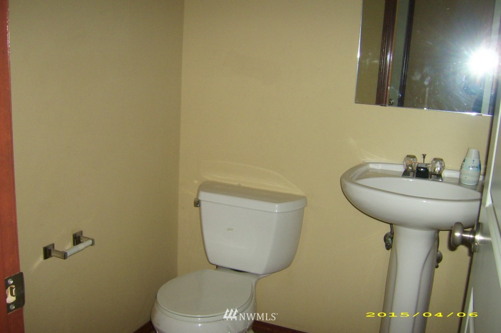 11911 East Gibson Road, Unit B Everett, WA 98204 - Photo 12 of 19 a bathroom with a toilet sink and mirror