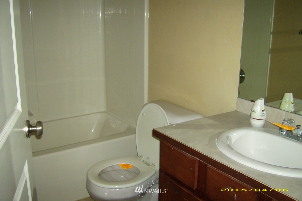 11911 East Gibson Road, Unit B Everett, WA 98204 - Photo 16 of 19 a bathroom with a sink a toilet and a mirror