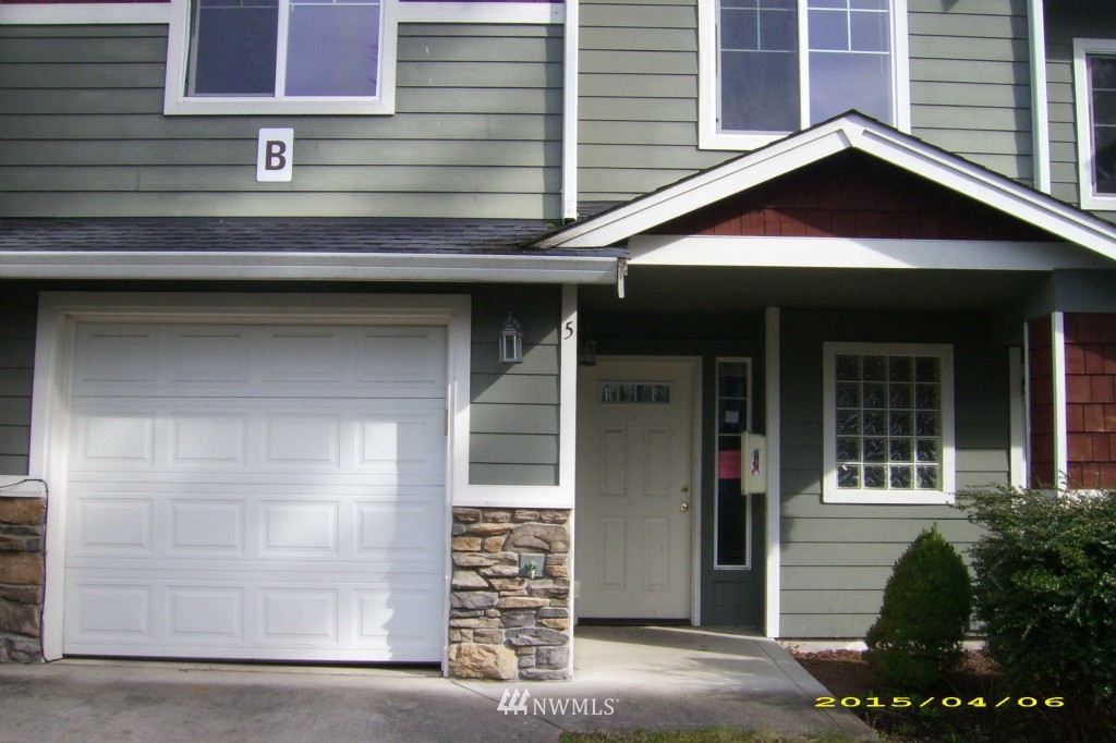 11911 East Gibson Road, Unit B Everett, WA 98204 - Photo 3 of 19 a front view of a house with a garage
