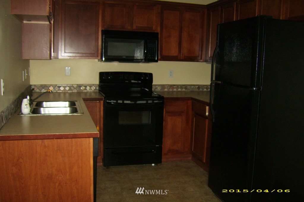 11911 East Gibson Road, Unit B Everett, WA 98204 - Photo 6 of 19 a kitchen with a refrigerator and a stove