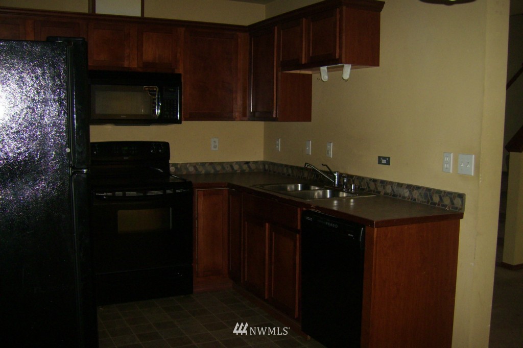 11911 East Gibson Road, Unit B Everett, WA 98204 - Photo 8 of 19 a kitchen with a sink a stove and cabinets