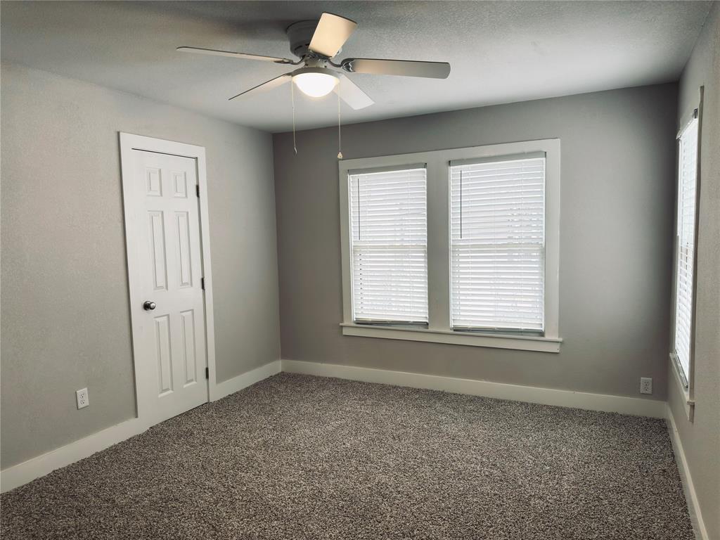 1908 South 19th Street Waco, TX 76706 - Photo 11 of 18 wooden floor in an empty room with a window