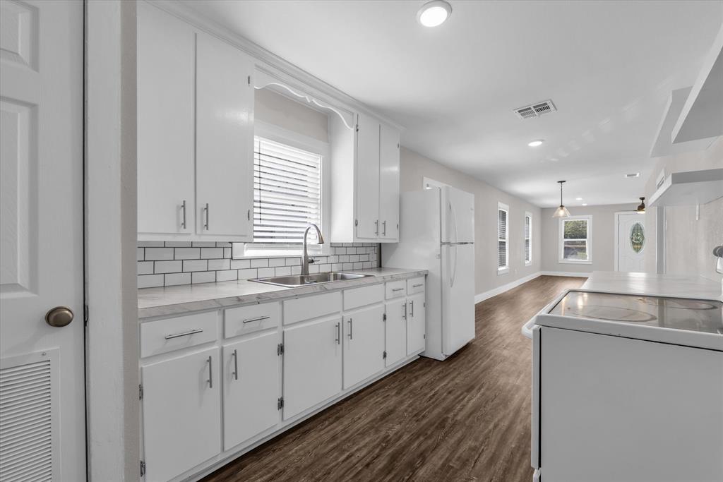 1908 South 19th Street Waco, TX 76706 - Photo 12 of 29 a large bathroom with a granite countertop double vanity sink a mirror and a bathtub