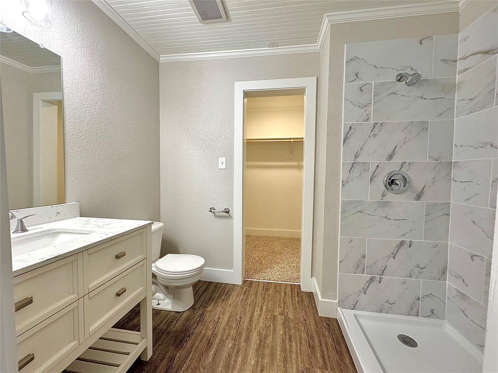 1908 South 19th Street Waco, TX 76706 - Photo 13 of 18 a bathroom with a sink a toilet and shower