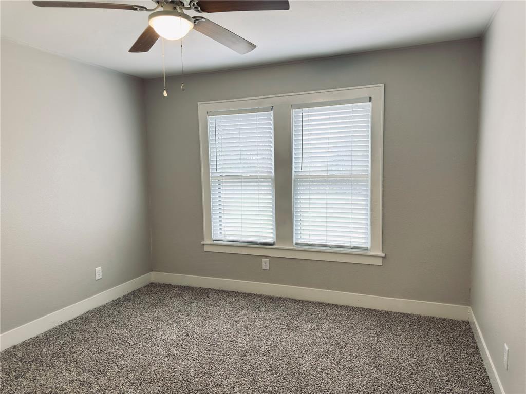 1908 South 19th Street Waco, TX 76706 - Photo 14 of 18 an empty room with a window and a fan