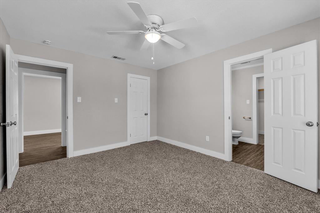 1908 South 19th Street Waco, TX 76706 - Photo 14 of 29 a view of an empty room with a ceiling fan