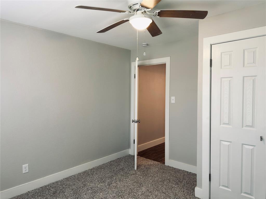 1908 South 19th Street Waco, TX 76706 - Photo 15 of 18 an empty room with closet and a chandelier fan