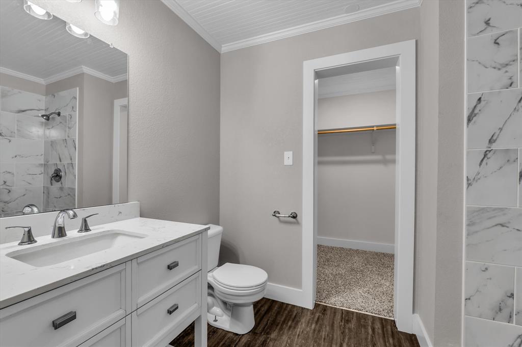 1908 South 19th Street Waco, TX 76706 - Photo 15 of 29 a bathroom with a sink a toilet and shower