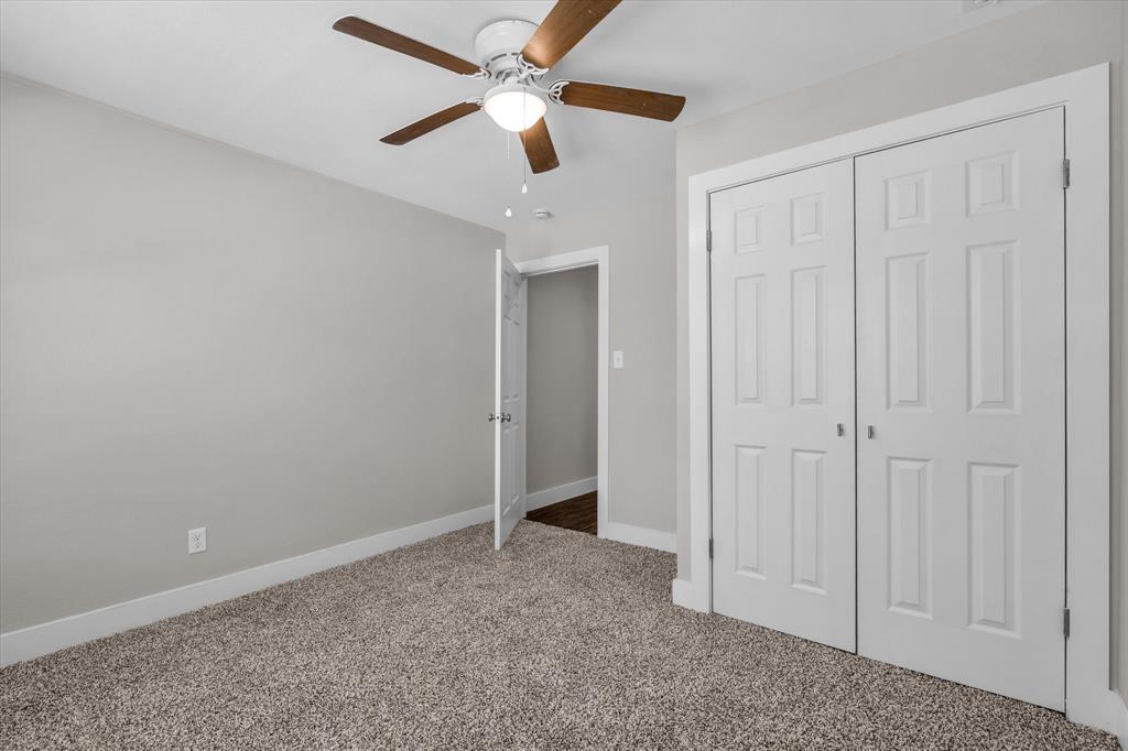 1908 South 19th Street Waco, TX 76706 - Photo 20 of 29 an empty room with closet and a chandelier fan