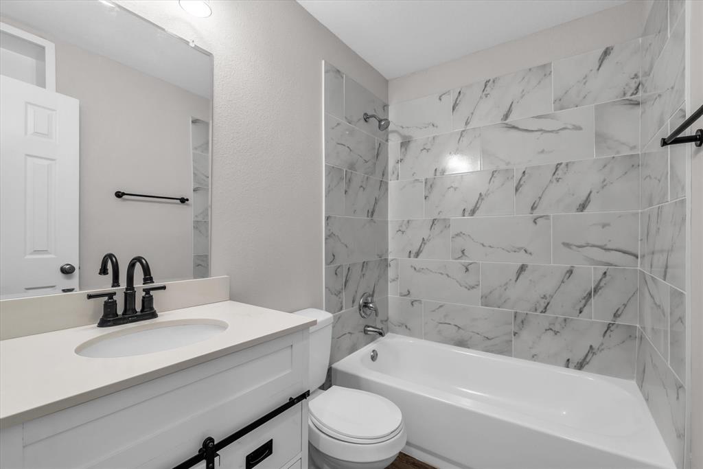 1908 South 19th Street Waco, TX 76706 - Photo 21 of 29 a bathroom with a sink a toilet and a bathtub
