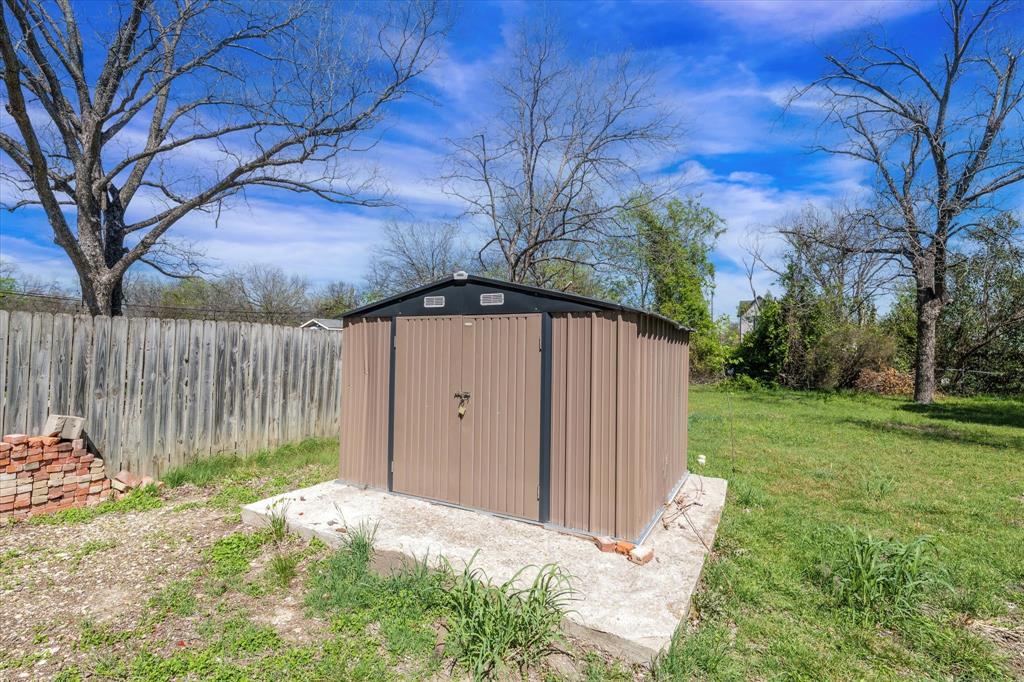 1908 South 19th Street Waco, TX 76706 - Photo 27 of 29 a view of a backyard with large trees and wooden fence