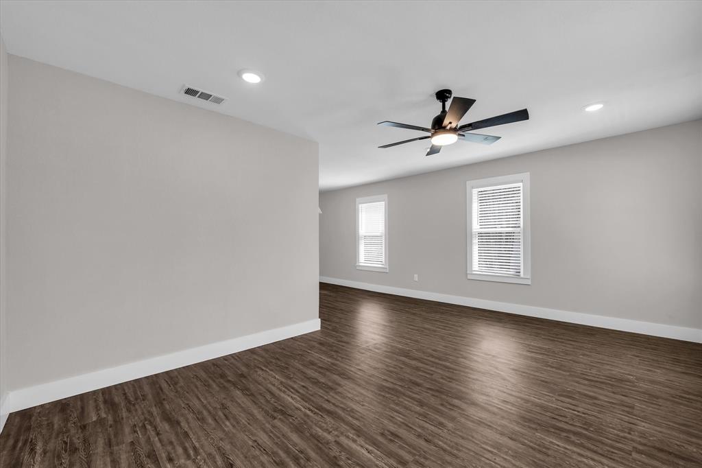 1908 South 19th Street Waco, TX 76706 - Photo 4 of 29 wooden floor in an empty room with a window