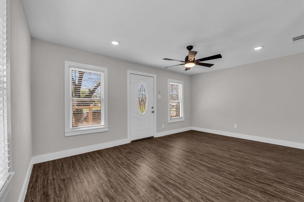 1908 South 19th Street Waco, TX 76706 - Photo 6 of 29 a view of an empty room with wooden floor and a window