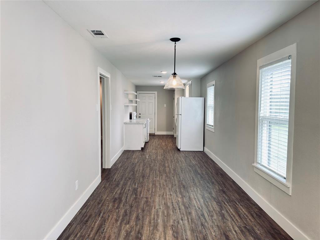 1908 South 19th Street Waco, TX 76706 - Photo 7 of 18 wooden floor in an empty room with a window