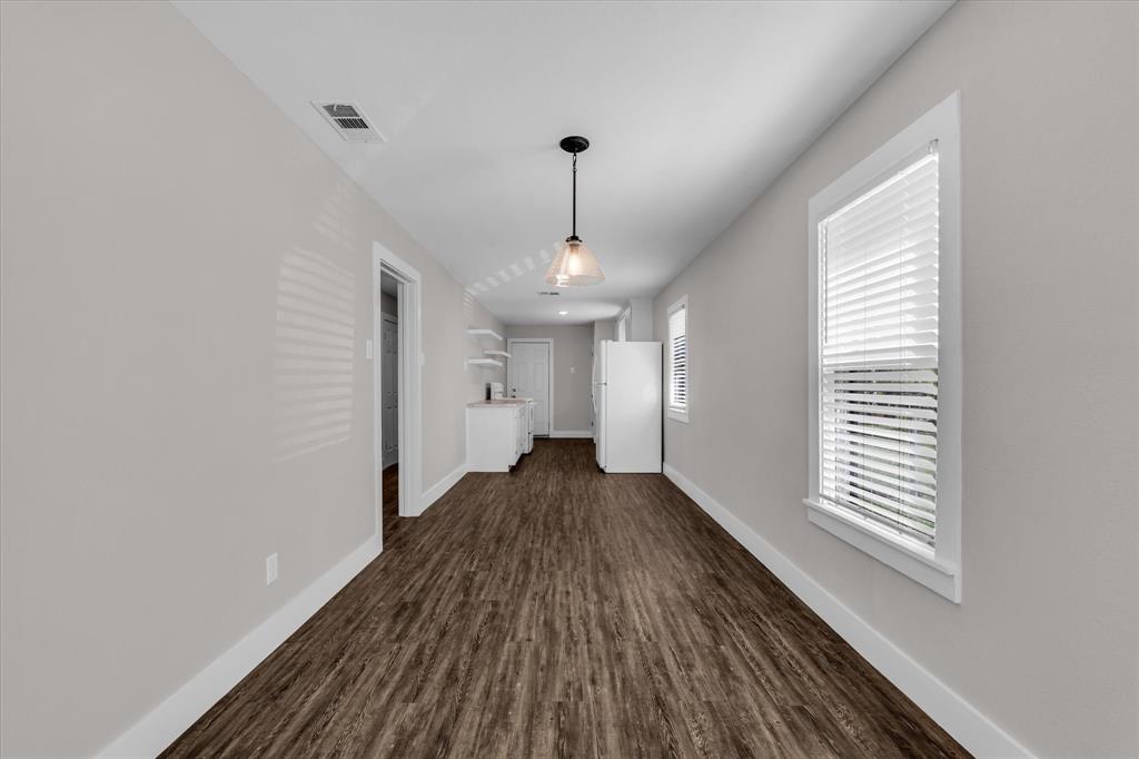 1908 South 19th Street Waco, TX 76706 - Photo 7 of 29 a view of a room with wooden floor ceiling fan and window