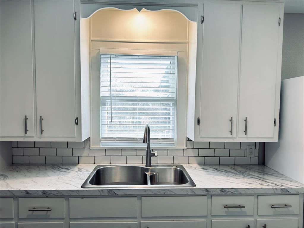 1908 South 19th Street Waco, TX 76706 - Photo 9 of 18 a kitchen with a sink and cabinets
