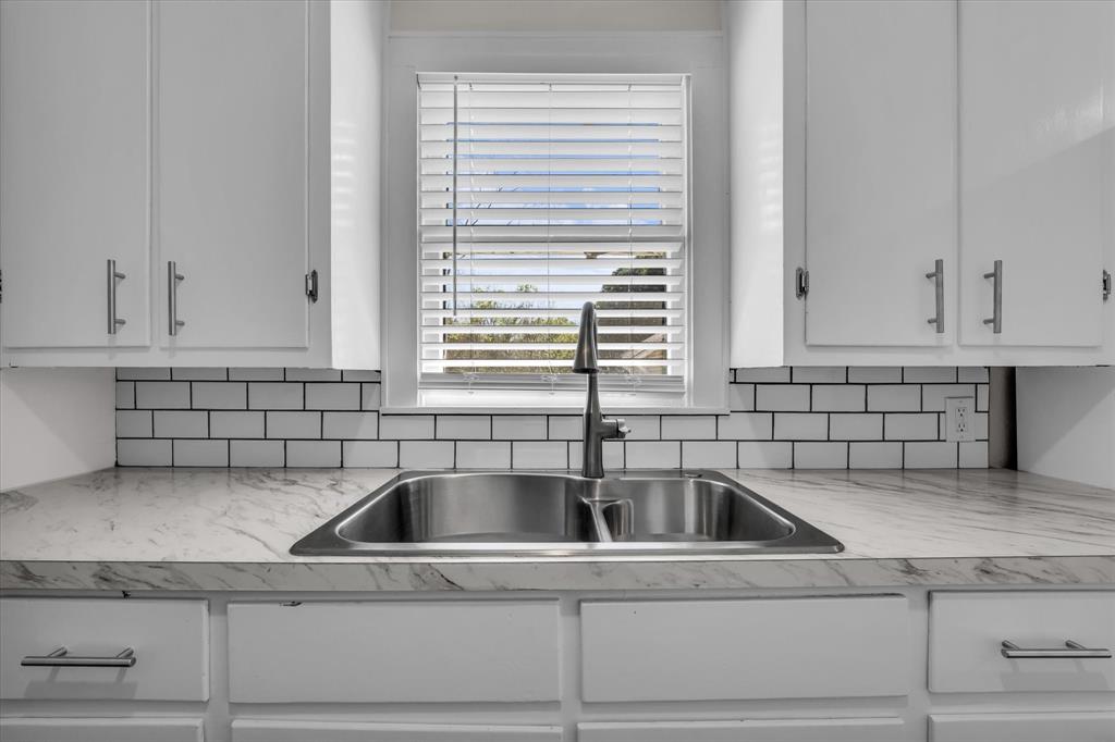 1908 South 19th Street Waco, TX 76706 - Photo 10 of 29 a kitchen with a sink cabinets and window