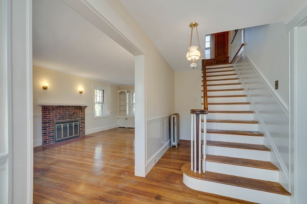 31 Ronald Road Arlington, MA 02474 - Photo 4 of 29 a view of a hallway with wooden floor and stairs