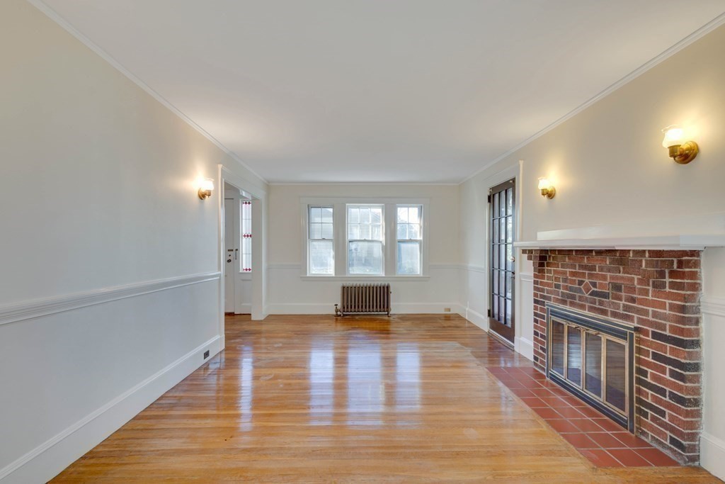 31 Ronald Road Arlington, MA 02474 - Photo 7 of 29 a view of an empty room with wooden floor and a window