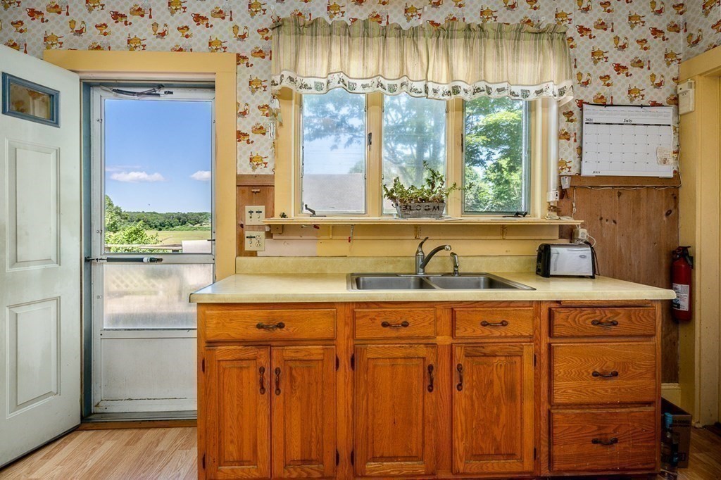 1054 County Road Bourne, MA 02534 - Photo 19 of 40 a kitchen with stainless steel appliances granite countertop a sink and a wooden cabinets